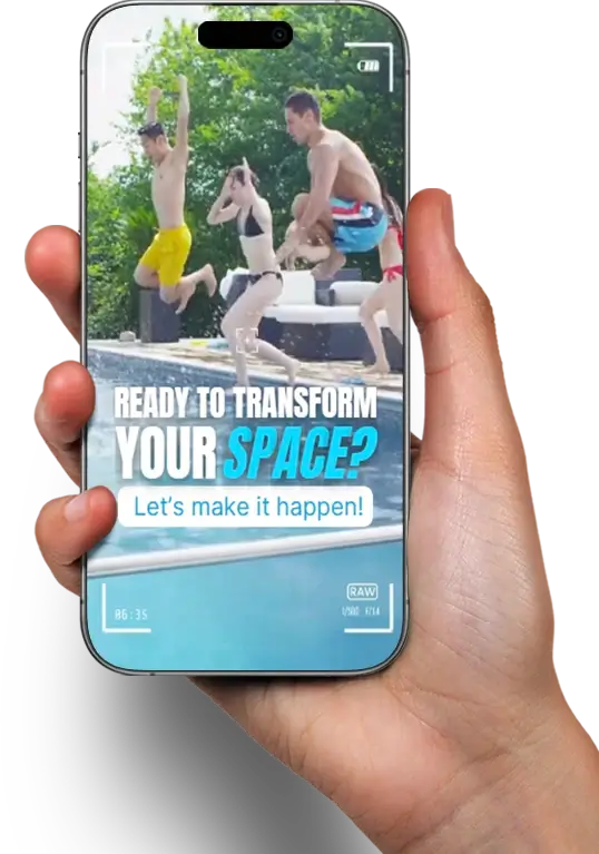 Hand holding a smartphone displaying a video of people jumping into a swimming pool, with overlay text ‘Ready to transform your space? Let’s make it happen!